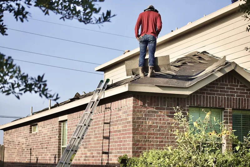 Professional roofer working on a residential roof in Pfafftown